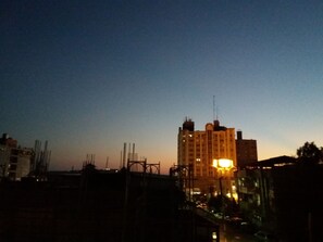 A high-rise building with a prominent antenna at the top, surrounded by other structures. - Heart Clear Good Homestay (Hengchun)