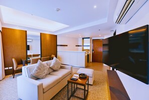 Seaview Two-Bedroom Suite | Living area | 65-inch LCD TV with cable channels, TV