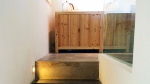 A staircase with a wooden cabinet at the top.