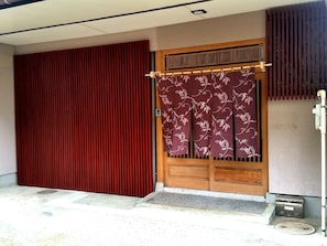 Traditional Japanese entrance with a sliding door and decorative panel.