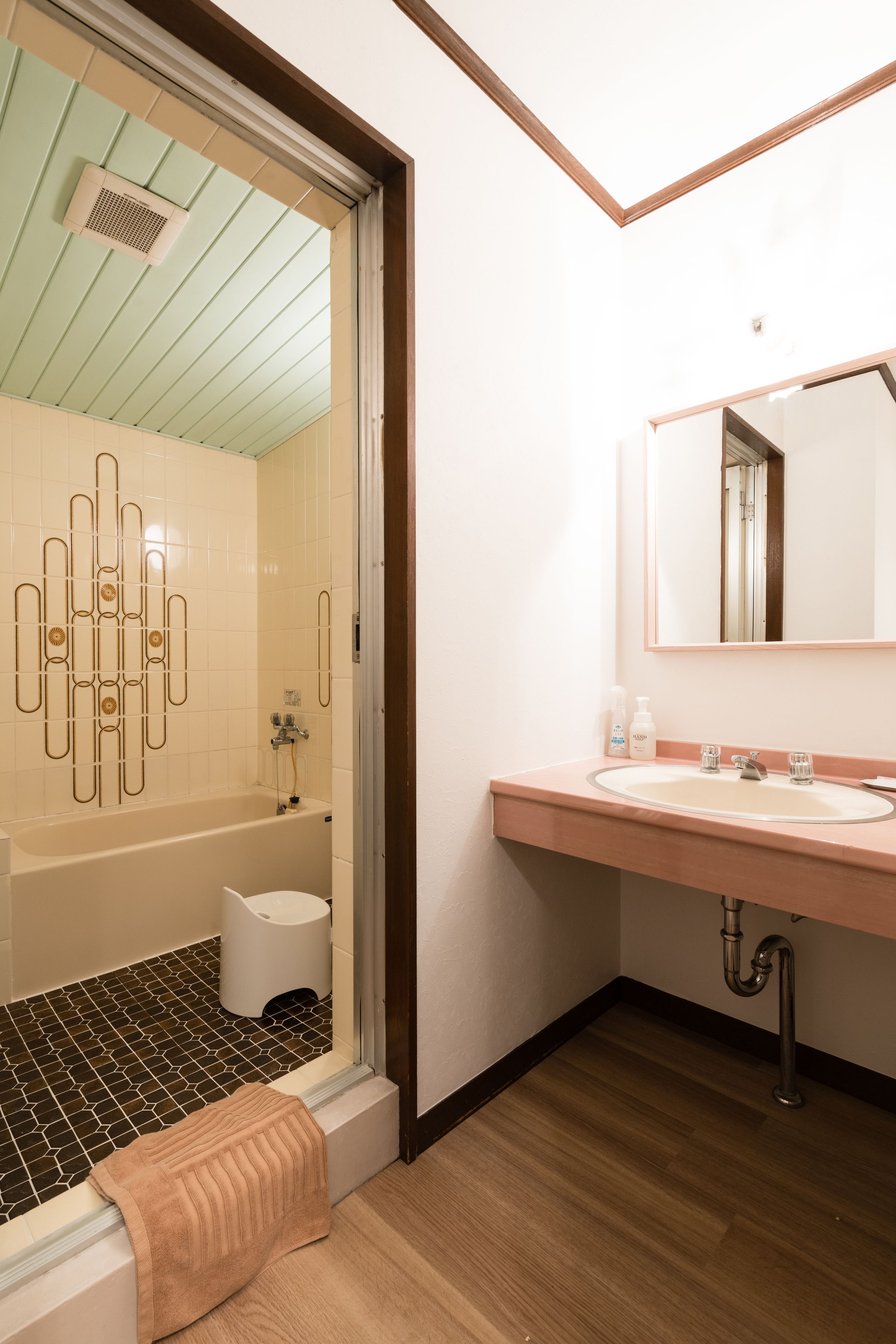 A modern bathroom with a bathtub, toilet, and sink.