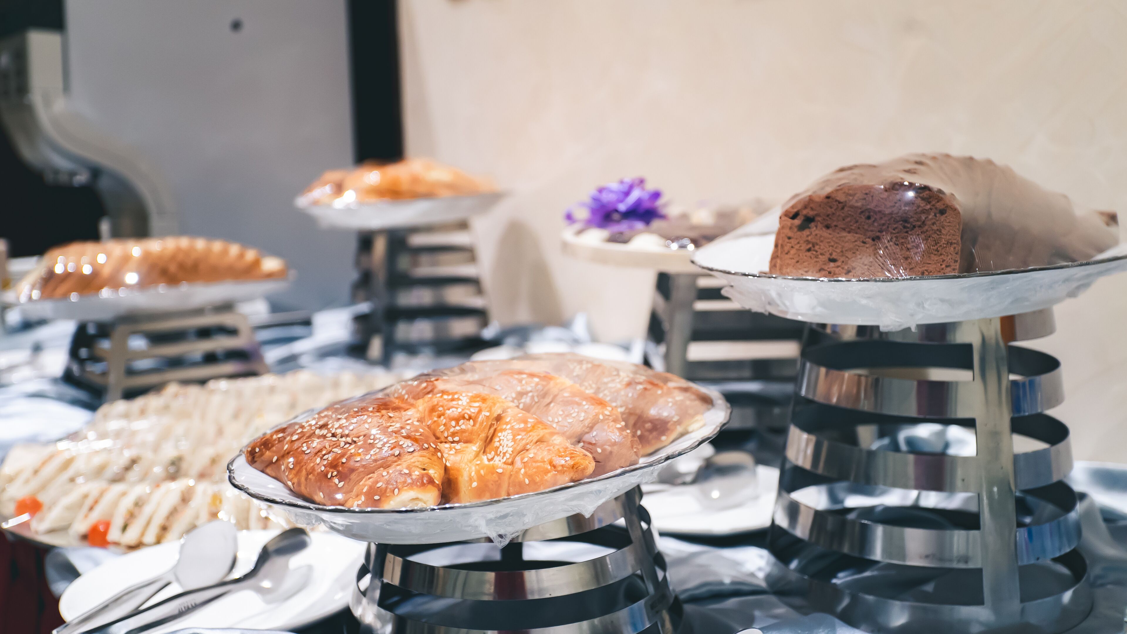 A buffet with various food items on metal stands.