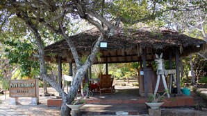 A thatched-roof pavilion with a sign reading "Puri Komodo Resort". - Puri Komodo Resort (Labuan Bajo)