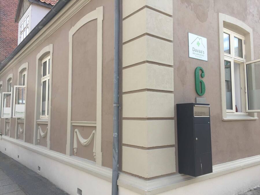 A building with a beige facade, a sign for 'Dava's Bed & Breakfast', and a mailbox with a green number '6'.