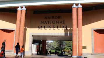 The entrance to the Nairobi National Museum with large columns and a clear sign above.