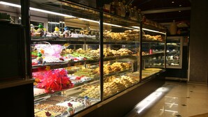 A bakery display case with various baked goods and pastries. - Cetin Otel (Kesan)