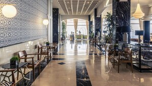 A spacious lobby with a patterned wall, marble flooring, and modern furniture. - Mercure San Sebastian Monte Igueldo (San Sebastián)