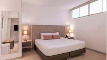 A modern hotel room with a large bed, bedside lamps, a nightstand, and a mirror.