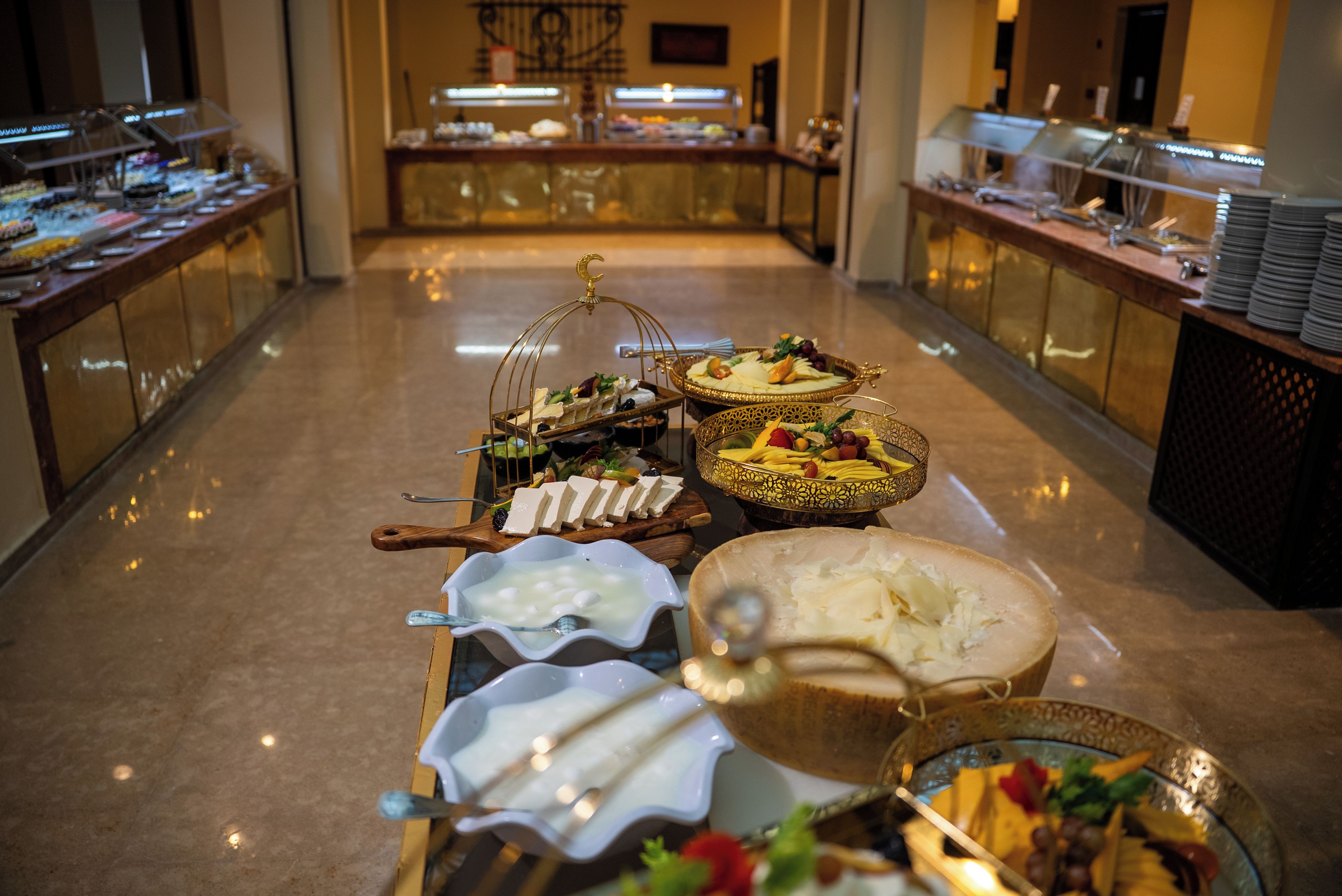 A buffet setup with various food items and a decorative centerpiece.