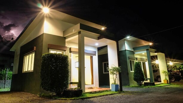 A modern two-story house with a well-lit entrance and large windows. - Bai Pai Resort (Khlung)