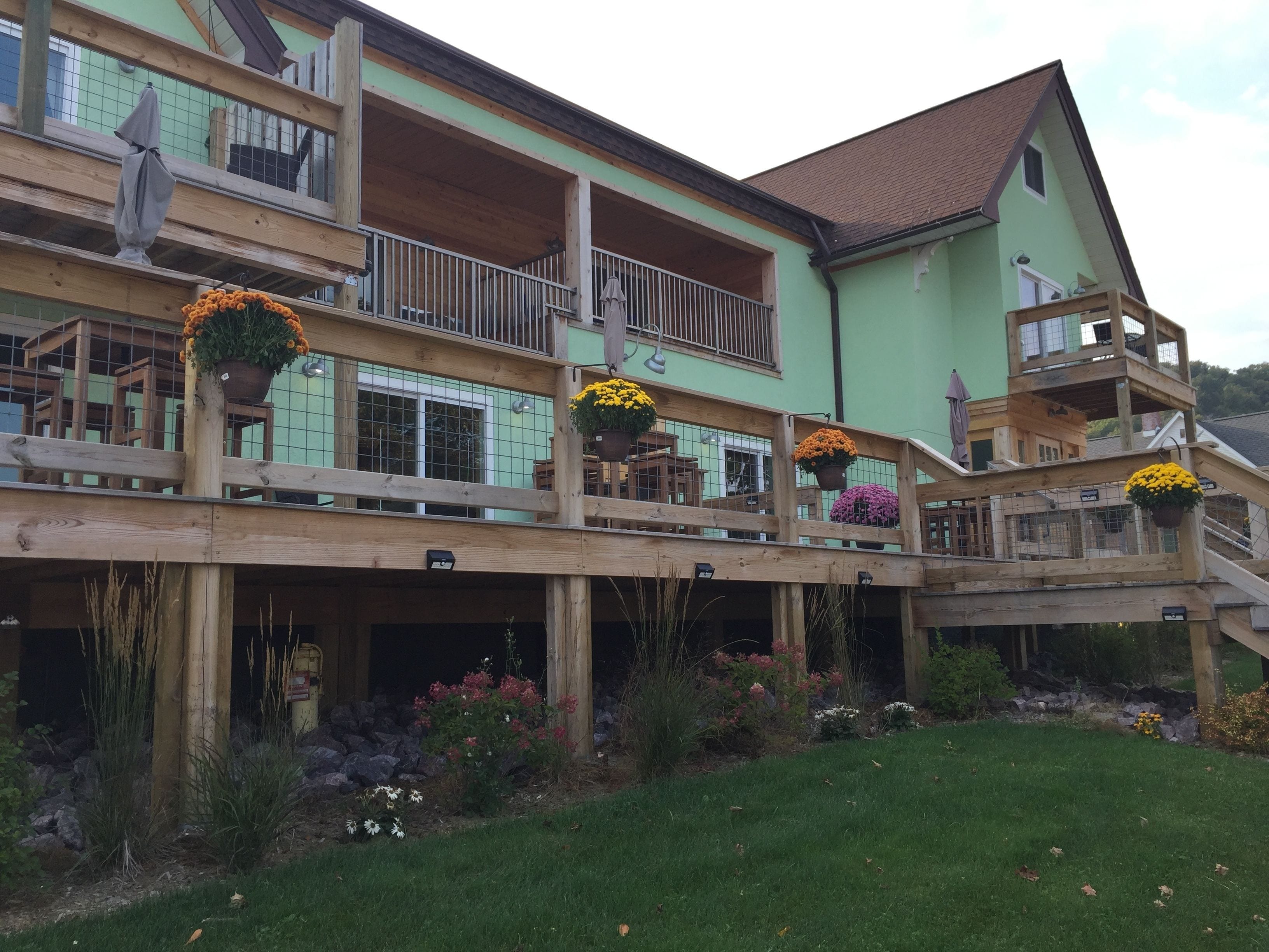 A multi-story building with wooden balconies and flower pots.