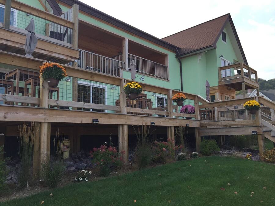 A multi-story building with wooden balconies and flower pots.