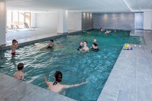 An indoor swimming pool with multiple lanes, tiled walls, and a clear view of the pool area. - Chalet in Paradiski with Pool & Spa (Plagne Villages)