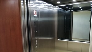 A modern elevator with metallic walls and a glass door. - Misol-Ha Hotel Mérida (Mérida)