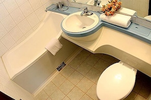 A bathroom with a bathtub, sink, and toilet.