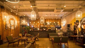 A cozy restaurant with wooden walls, hanging light fixtures, and a bar area. - Christmas Resort (Jeju City)