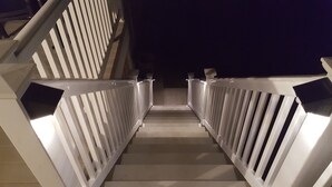 A staircase with white railings and a handrail, leading to a dark area beyond. - Great Location In Cape May, NJ. Just 4 Blocks To Beach And Washington St Mall (Cape May)