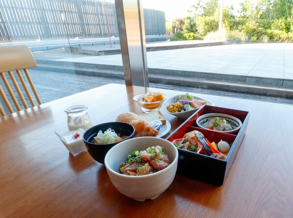 A table with various dishes, a glass of milk, and a small jar of condiments. - JR KYUSHU HOTEL Blossom Oita (Oita)
