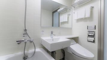 Un baño moderno con bañera, lavamanos e inodoro.