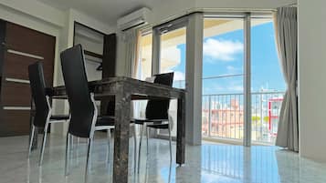 Standard Quadruple Room, Kitchen | Living area | Flat-screen TV