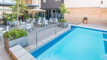 Alberca al aire libre y camastros