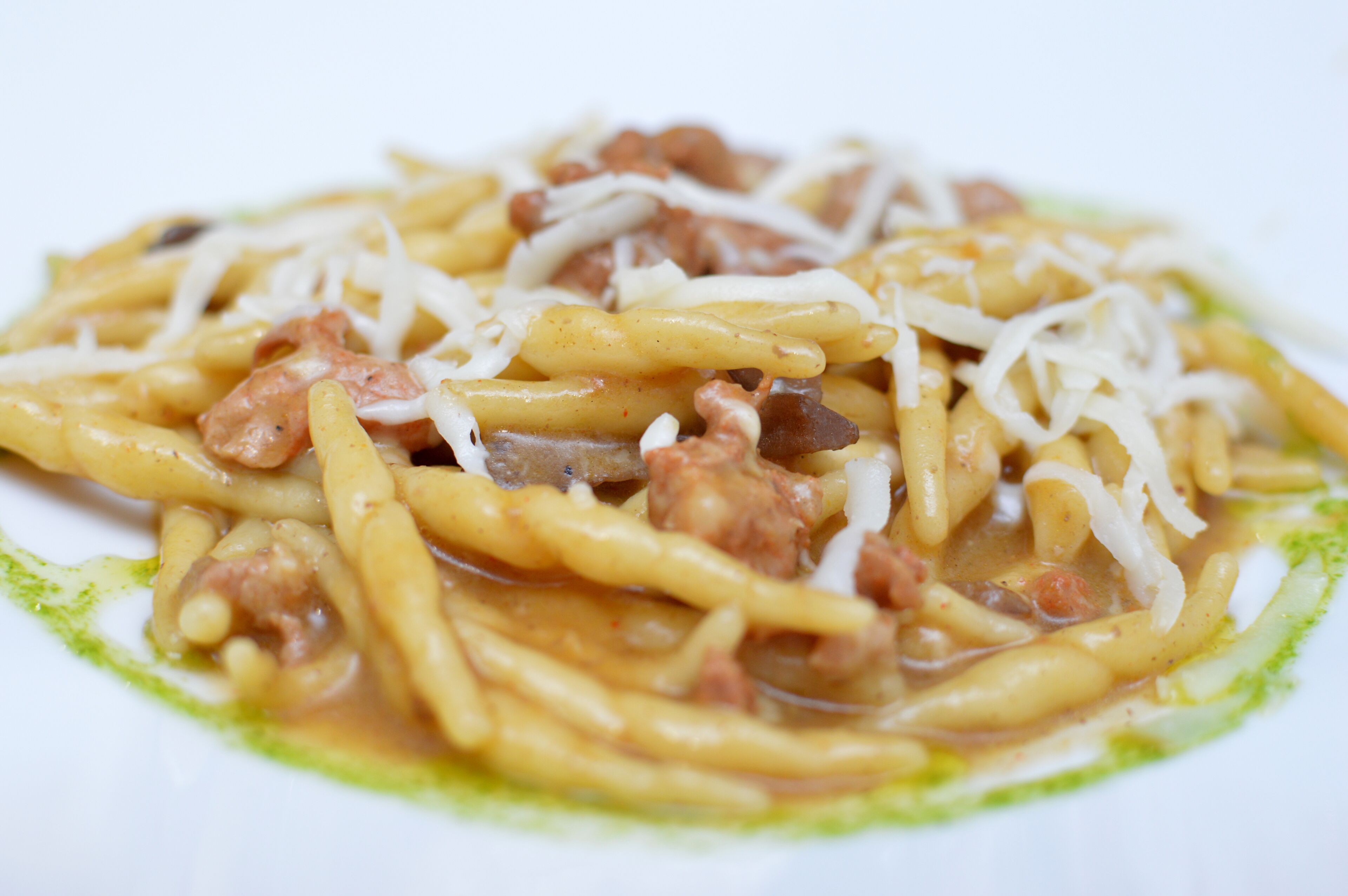 A plate of spaghetti with meat and cheese.