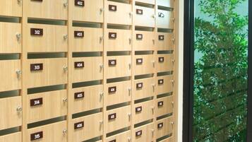 A row of wooden lockers with numbers on them, arranged in a row.
