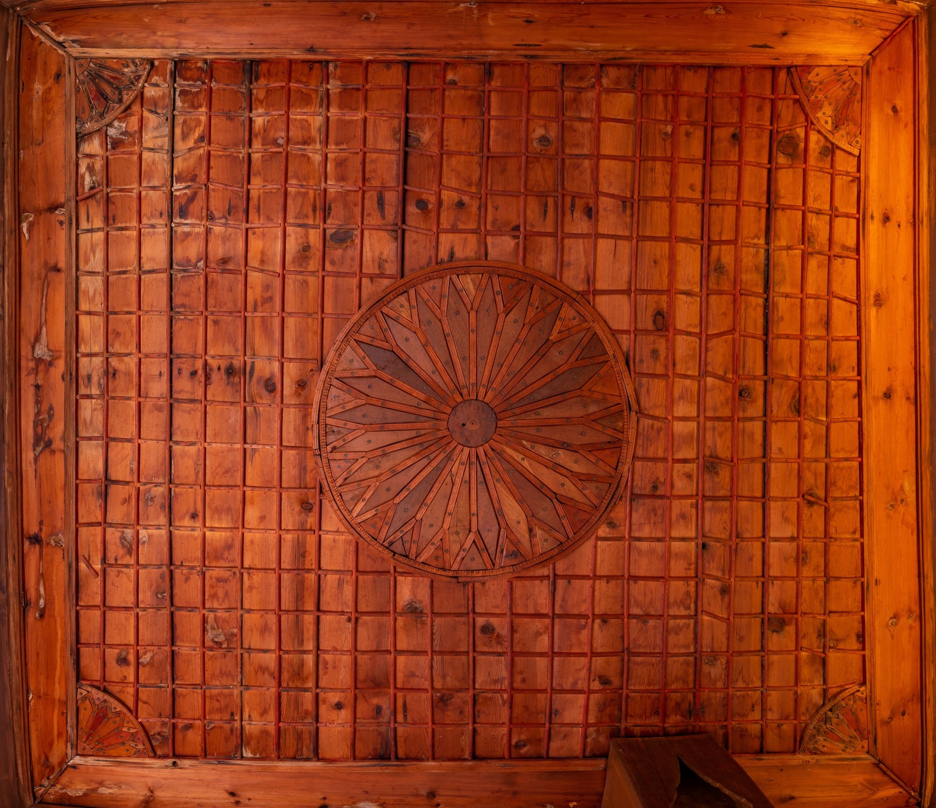 A wooden wall with a circular decorative element.