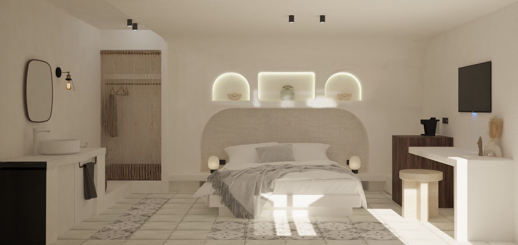 Un dormitorio moderno con una cama grande, mesitas de noche, un banco empotrado, un televisor montado en la pared y un baño con lavamanos y espejo.