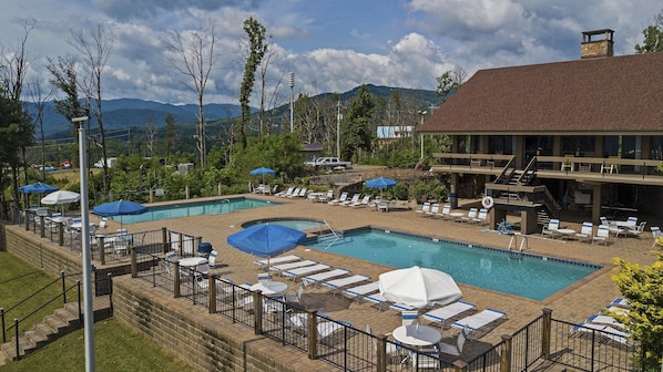 A resort with multiple swimming pools, sun loungers, and umbrellas. - Bearly Hidden Ridge 5 Bedroom Cabin by RedAwning (Gatlinburg)