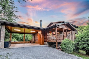 A wooden cabin with a covered patio and a balcony. - The Ranch Cabin on 6 Secluded Acres in the Great Smoky Mountains by RedAwning (Sevierville)