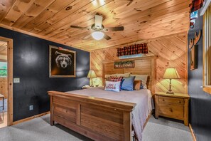 A wooden ceiling fan, a bed with a pillow labeled "SKI LODGE", and a "WELCOME" sign on the wall. - The Ranch Cabin on 6 Secluded Acres in the Great Smoky Mountains by RedAwning (Sevierville)
