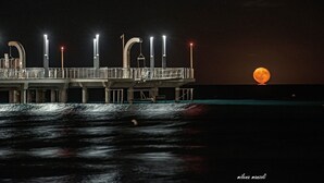 A pier with a moon in the background. - Hotel Aida (Alassio)