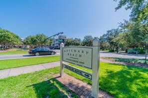 A sign for Rosemary Beach with a clear road and greenery in the background. - Pompano Palace - 4 Br home by RedAwning (Panama City Beach)