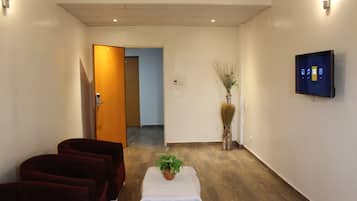 Deluxe Room | Living room | Flat-screen TV