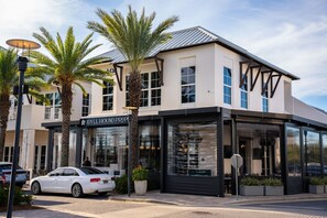 A modern building with a storefront labeled 'IDYLL HOUND PROPERTY.' - Shoreline Townhomes #10 - 2 Br townhouse by RedAwning (Panama City Beach)