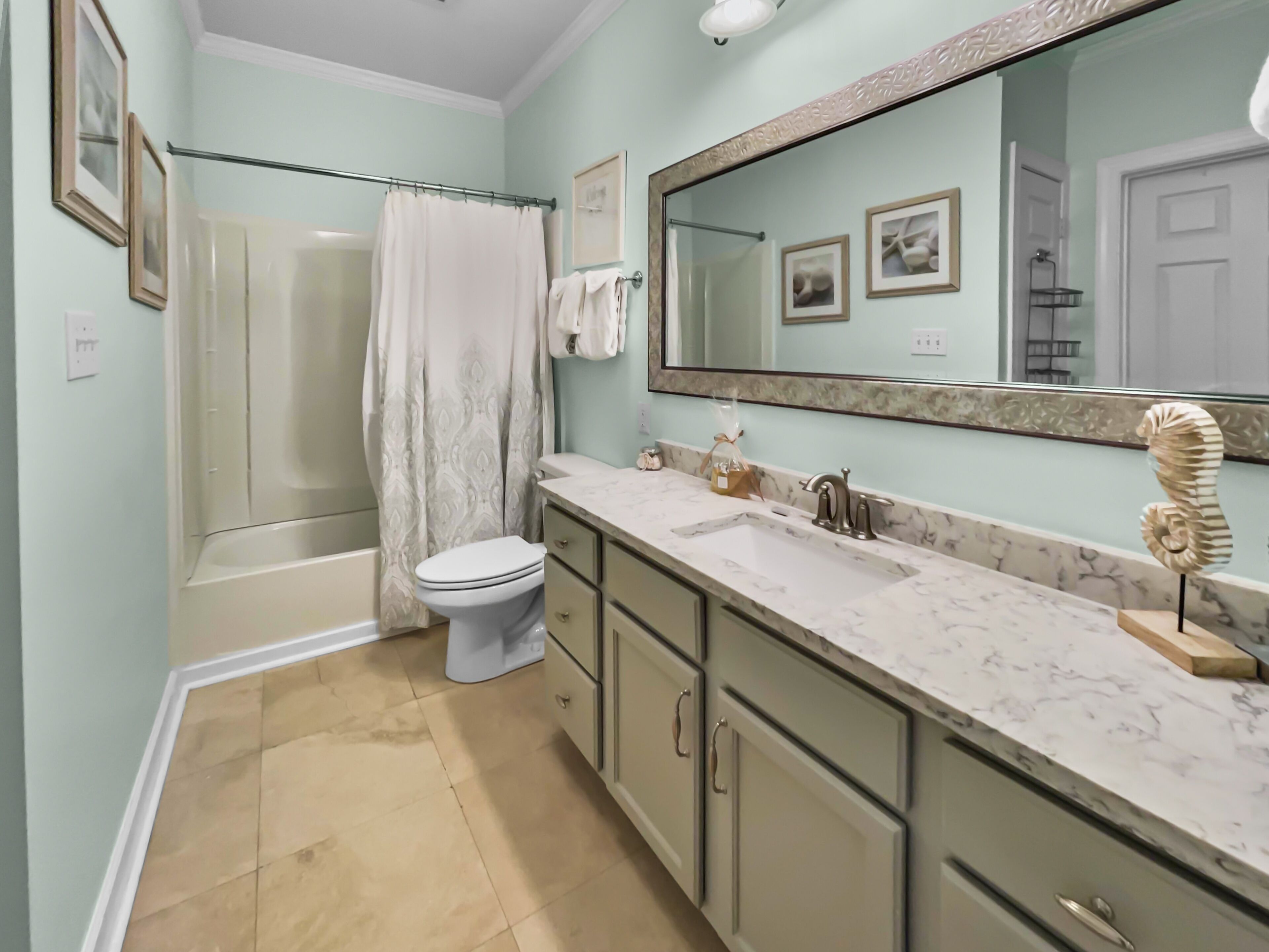 A bathroom with a bathtub, toilet, and sink.