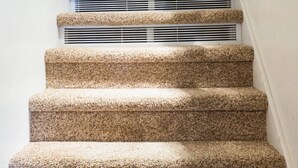 A staircase with carpeted steps and a wooden handrail. - Ski Trails 4058 (Truckee)
