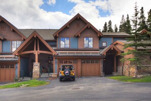 A large, multi-story house with a prominent front porch and garage doors. - 2br 2ba Winter  Walk To Historic Downtown + Gondola 2 Bedroom Townhouse by RedAwning (Breckenridge)