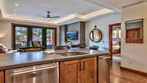 A modern kitchen with a large island, stainless steel appliances, and a view of the outdoors. - LuxuryÂ 2br  Steps From Heavenly Village & Gondola 2 Bedroom Condo by RedAwning (South Lake Tahoe)