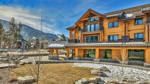 A large wooden lodge with multiple balconies and large windows, set against a mountainous backdrop. - LuxuryÂ 2br  Steps From Heavenly Village & Gondola 2 Bedroom Condo by RedAwning (South Lake Tahoe)