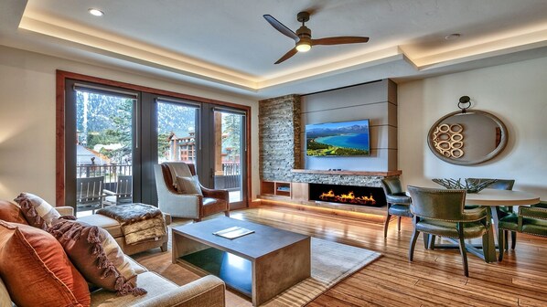 A spacious living room with a fireplace, comfortable seating, and a large TV. - LuxuryÂ 2br  Steps From Heavenly Village & Gondola 2 Bedroom Condo by RedAwning (South Lake Tahoe)