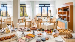A breakfast buffet with various food items and a wine selection. - Hotel Europa (Finale Ligure)