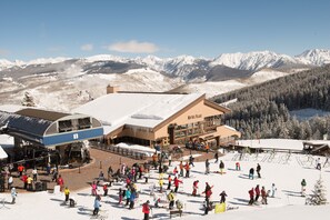 A ski resort with a large building, a ski lift, and a snowy mountain backdrop. - Ritz Carlton Residence Spacious with Valley Views by RedAwning (Vail)