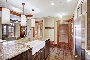 A kitchen with granite countertops, stainless steel appliances, and wooden cabinetry.