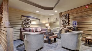 A modern living room with a sofa, two armchairs, a coffee table, and a fireplace. - Luxury Studio  Steps From Winter Activities, Sleeps 4! Studio Bedroom Condo by RedAwning (Breckenridge)