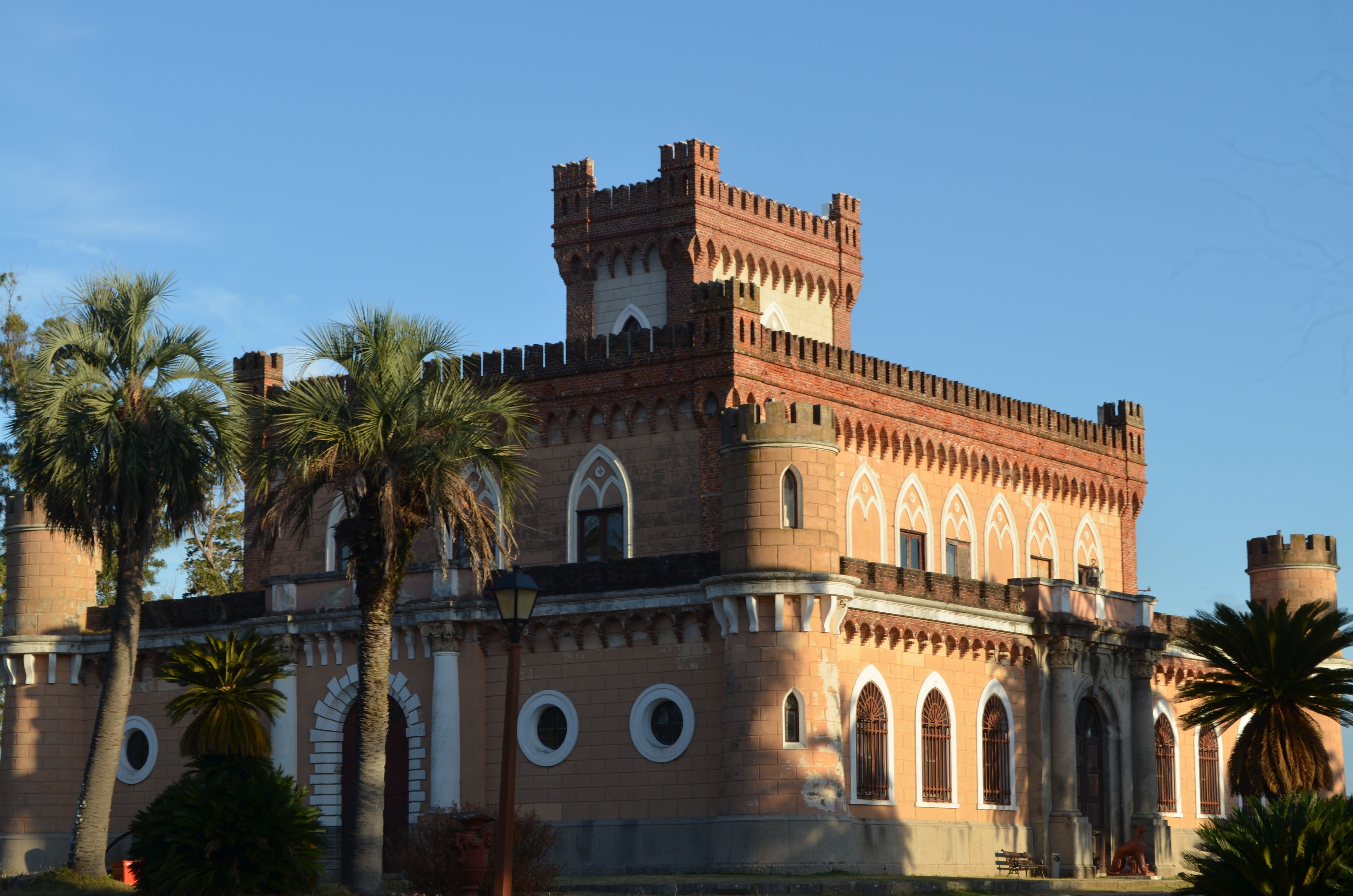 A historic building with arched windows and a central tower.