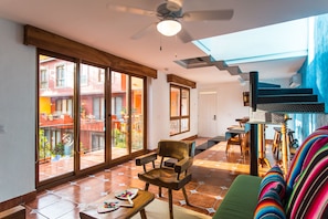 Two Bedroom Master Suite with Balcony, Kitchenette and Pool View | Living room | 55-inch Smart TV with satellite channels, TV