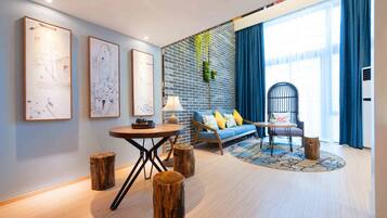 Loft King Room | Living area | 50-inch flat-screen TV with cable channels, TV