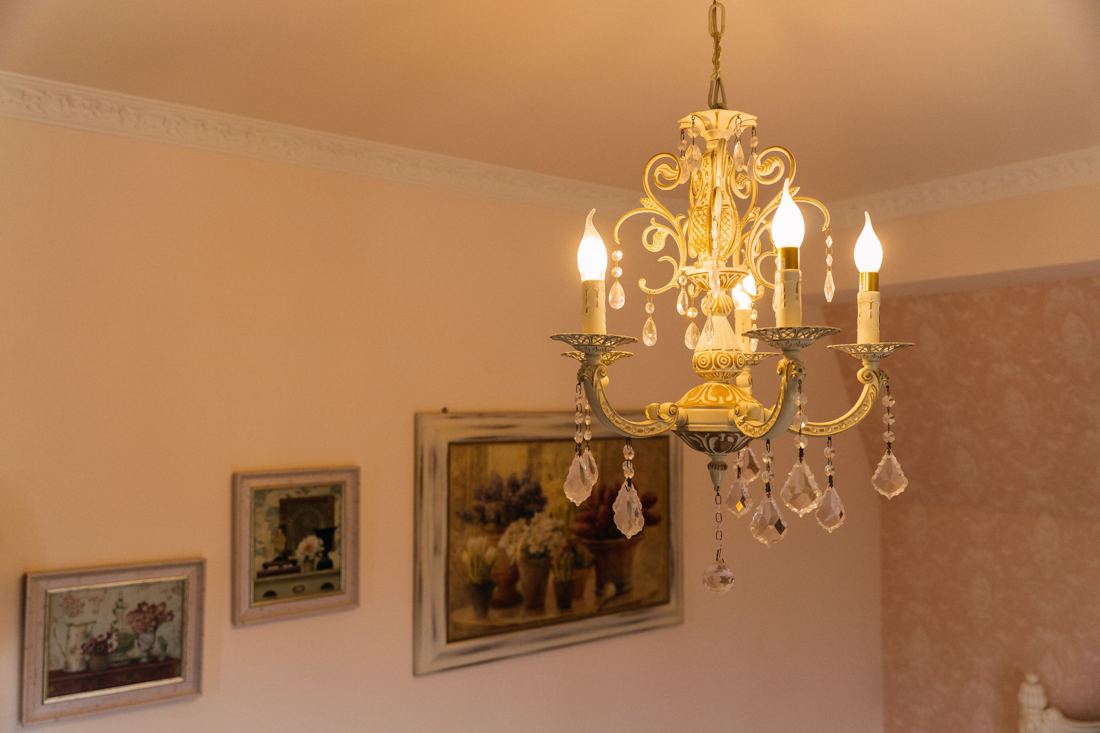 A chandelier with multiple candle-like lights and crystal decorations.